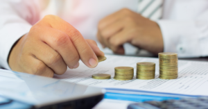 image that shows corporate person counting money in order to reference the capital stack