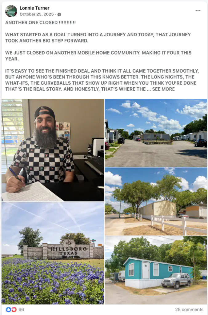 Bearded man in a black-and-white checkered shirt signs a document at a desk indoors, smiling at the camera.