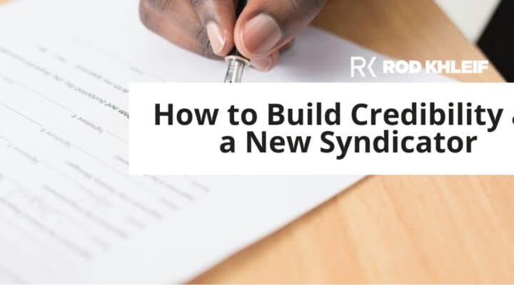 Rod Khleif featured image for How to Build Credibility as a New Syndicator, showing hands signing a business contract on a wooden desk with the RK brand logo, representing the trust and credibility a new multifamily syndicator builds before their first deal.