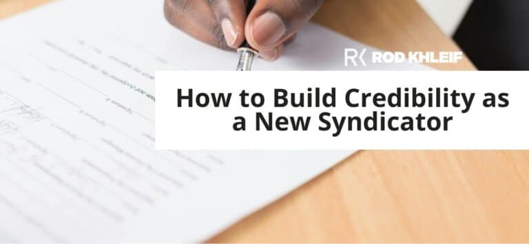 Rod Khleif featured image for How to Build Credibility as a New Syndicator, showing hands signing a business contract on a wooden desk with the RK brand logo, representing the trust and credibility a new multifamily syndicator builds before their first deal.