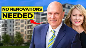 Man in a blue suit with a smiling woman behind him, in front of a building, under a bold yellow banner reading NO RENOVATIONS NEEDED.