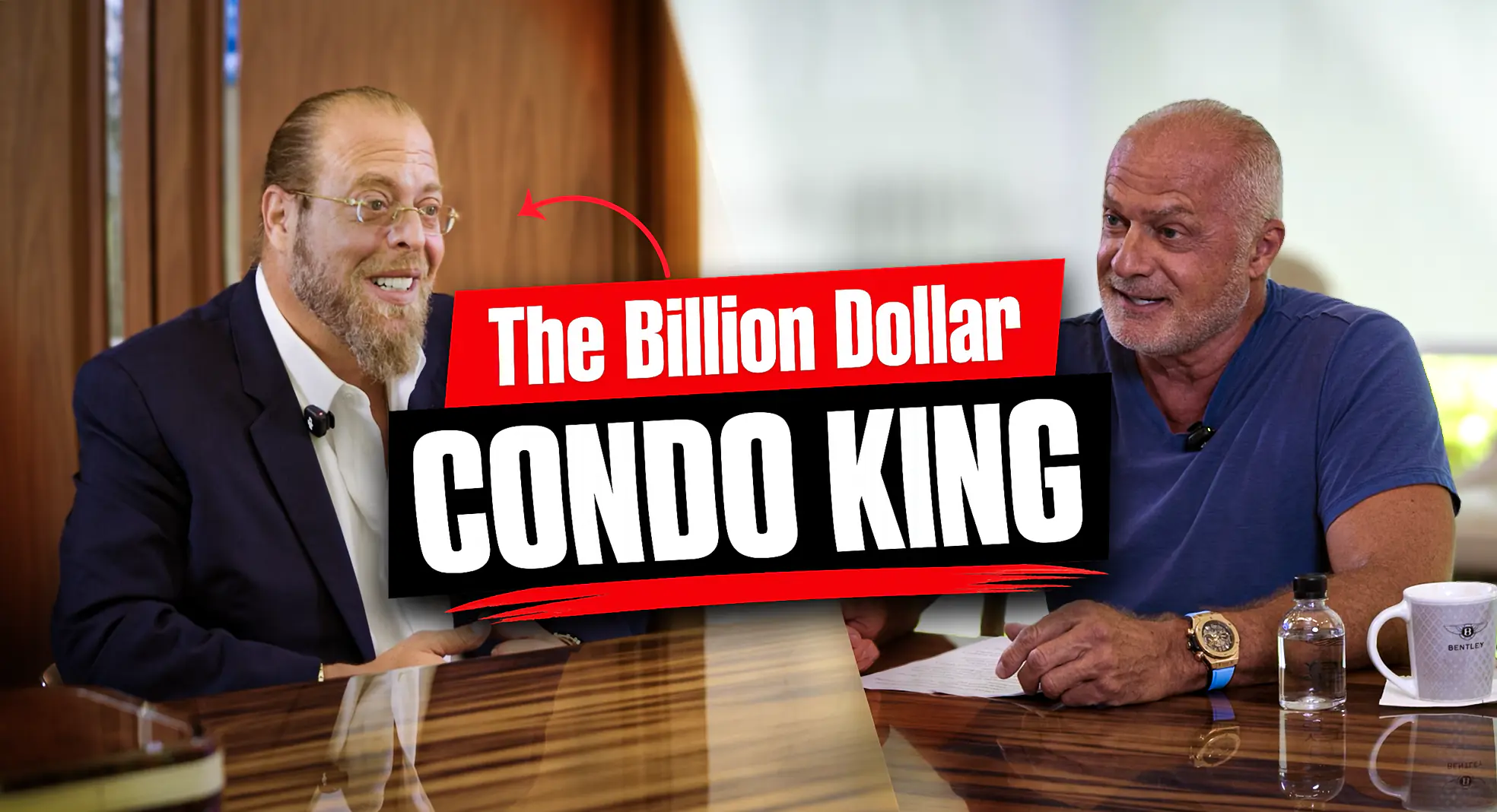 Two men sit at a glossy table in discussion, with a bold red-and-black graphic reading 'The Billion Dollar Condo King' over the image.
