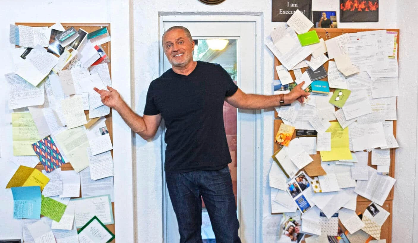 Image of Rod Khleif standing in front of hundreds of thank you notes.